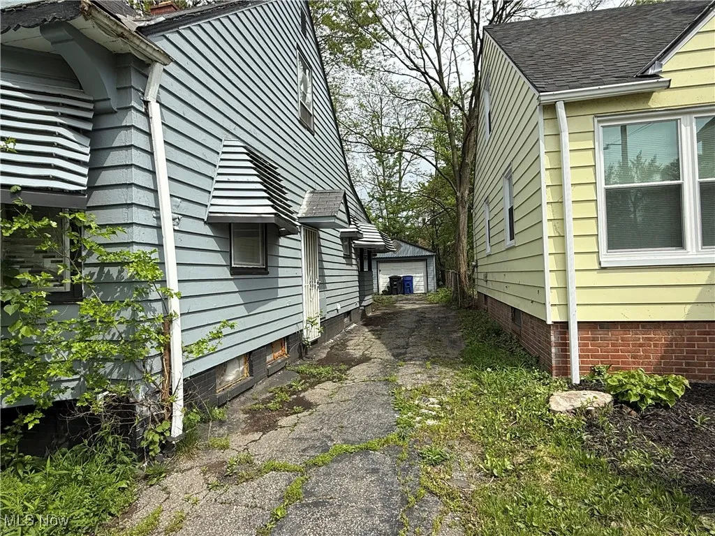 View of side of property with a garage and an outdoor structure