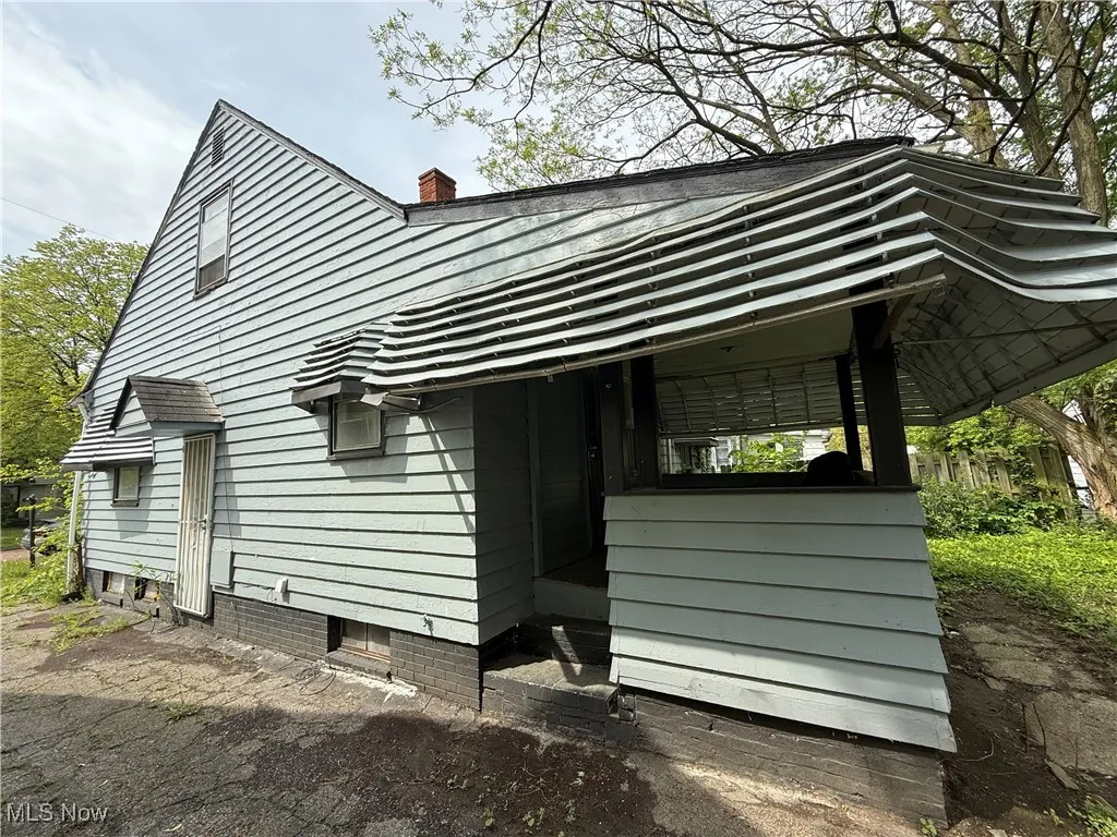 View of side of property featuring a chimney
