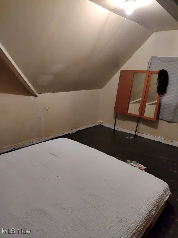 Bedroom with lofted ceiling