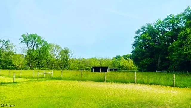 View of yard featuring a rural view and a forest view