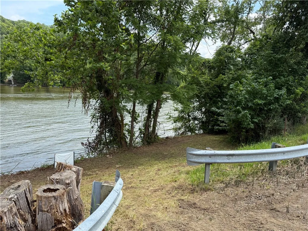 View of yard featuring a water view and a fire pit