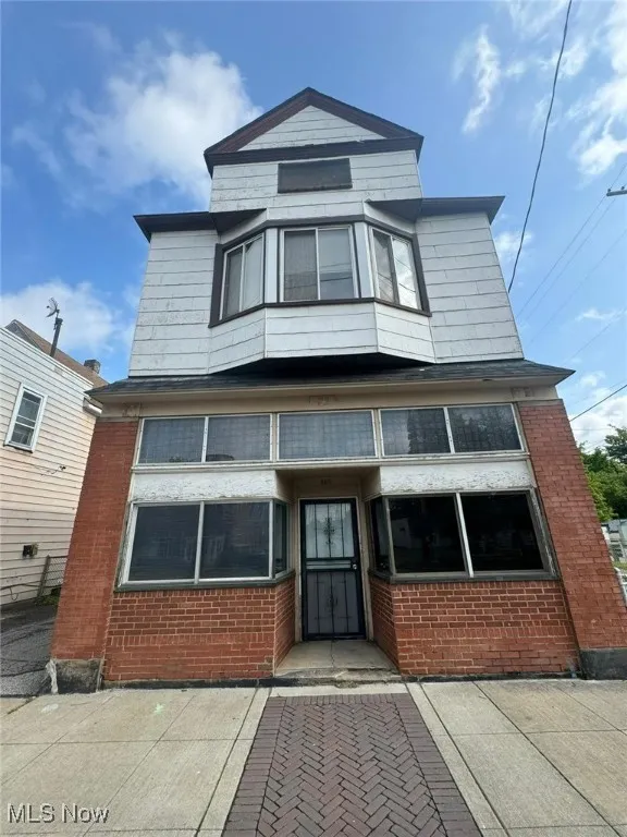 View of front facade featuring brick siding
