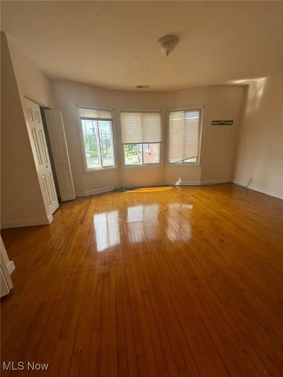 Unfurnished room featuring baseboards and wood-type flooring