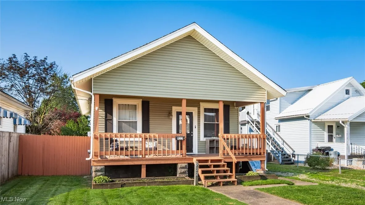 View of front of home featuring covered porch and stairway