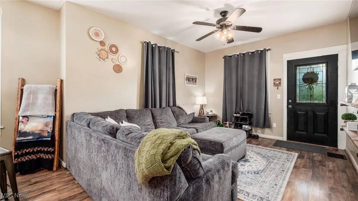 Living room with wood finished floors and ceiling fan