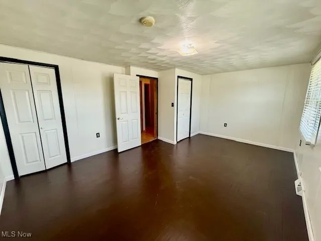 Unfurnished bedroom featuring baseboards