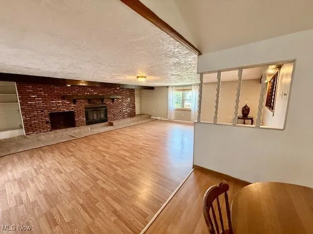 Living room with wood finished floors and a fireplace
