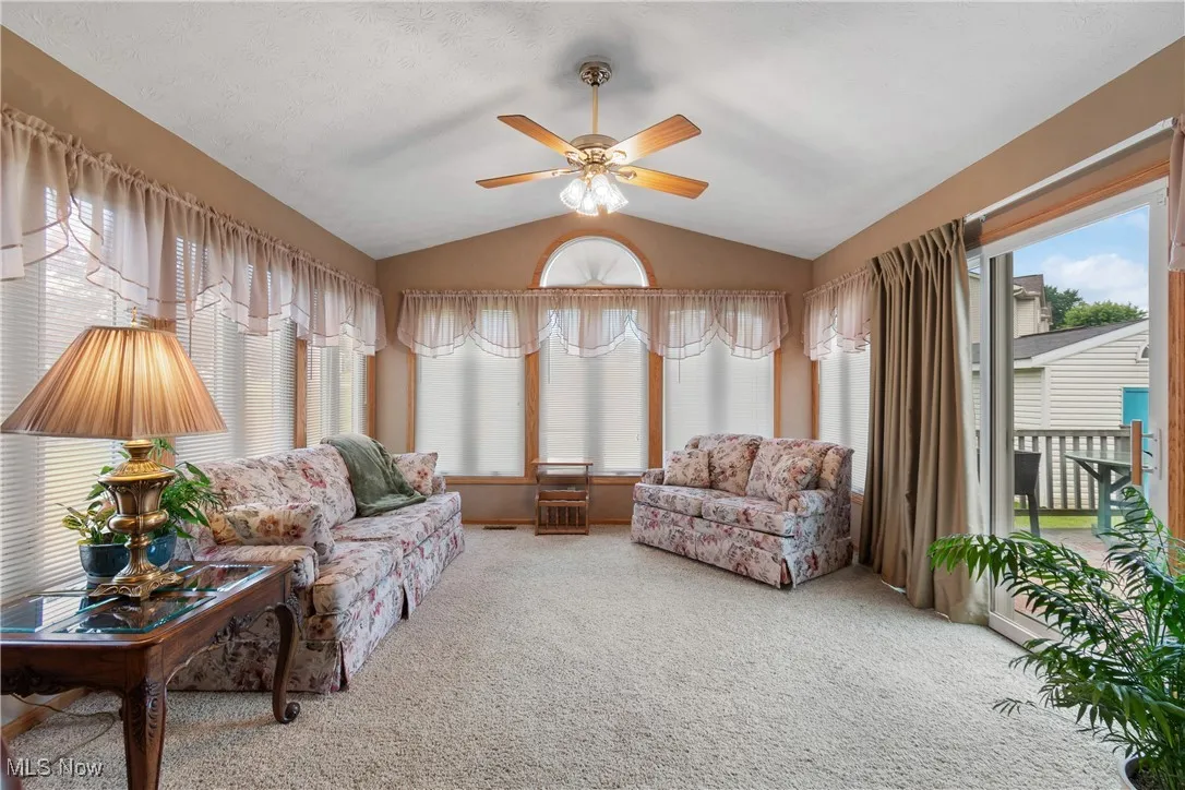 Sun room has loads of natural light and opens to deck and back yard.