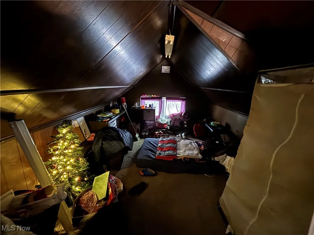 Bedroom with lofted ceiling and carpet floors
