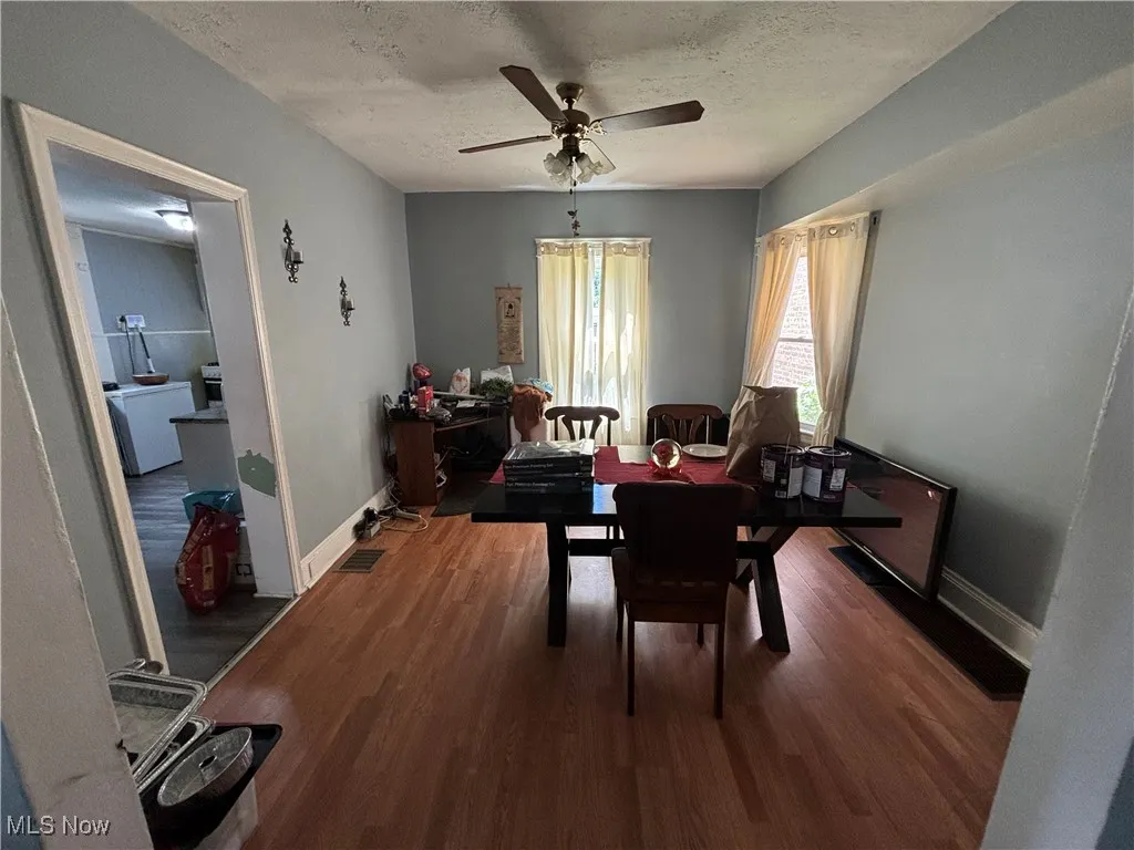 Dining area featuring ceiling fan, wood finished floors, a textured ceiling, and baseboards