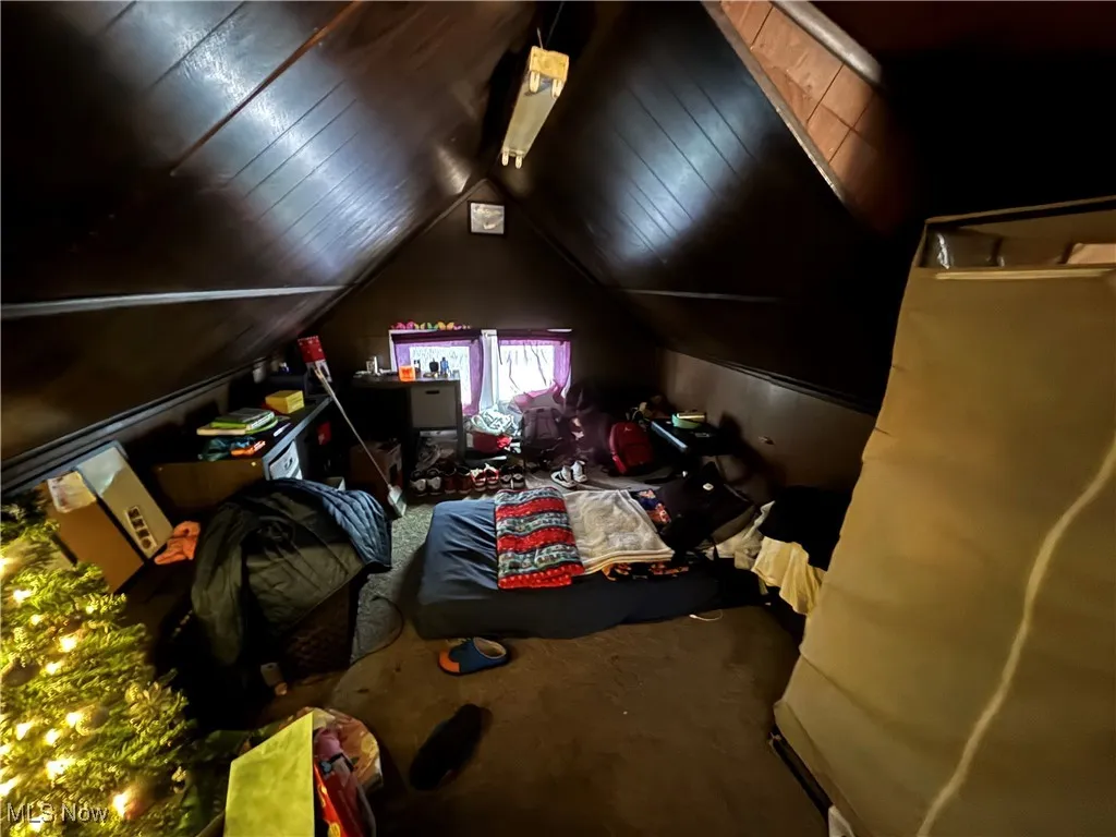 Bedroom featuring carpet and lofted ceiling