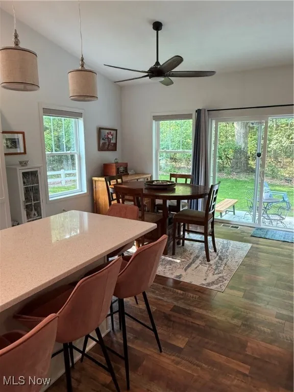 Dining area featuring lofted ceiling, healthy amount of natural light, ceiling fan, and dark wood-style floors. Surrounded by Cassell Reservation everywhere you look!