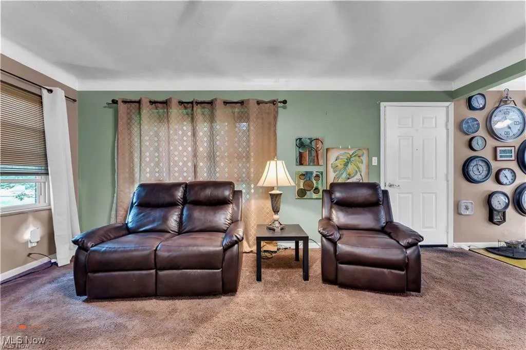Carpeted living room with baseboards