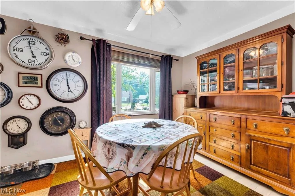 Dining area with ceiling fan and baseboards