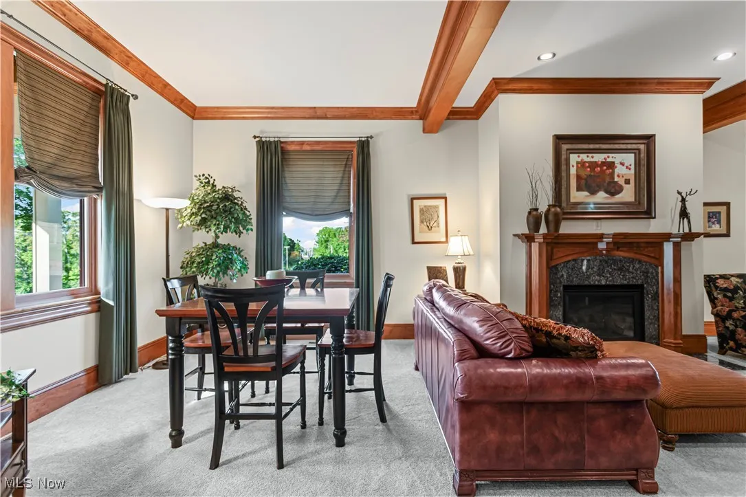 Living room featuring light colored carpet, healthy amount of natural light, baseboards, ornamental molding, and recessed lighting