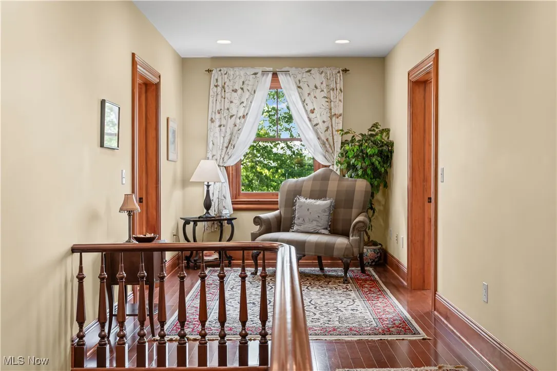 Sitting room with wood-type flooring, baseboards, and recessed lighting