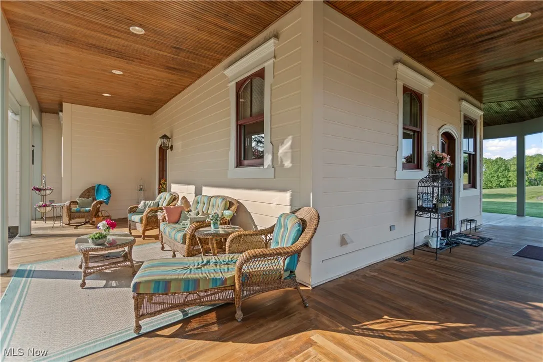 Wooden porch featuring an outdoor living space
