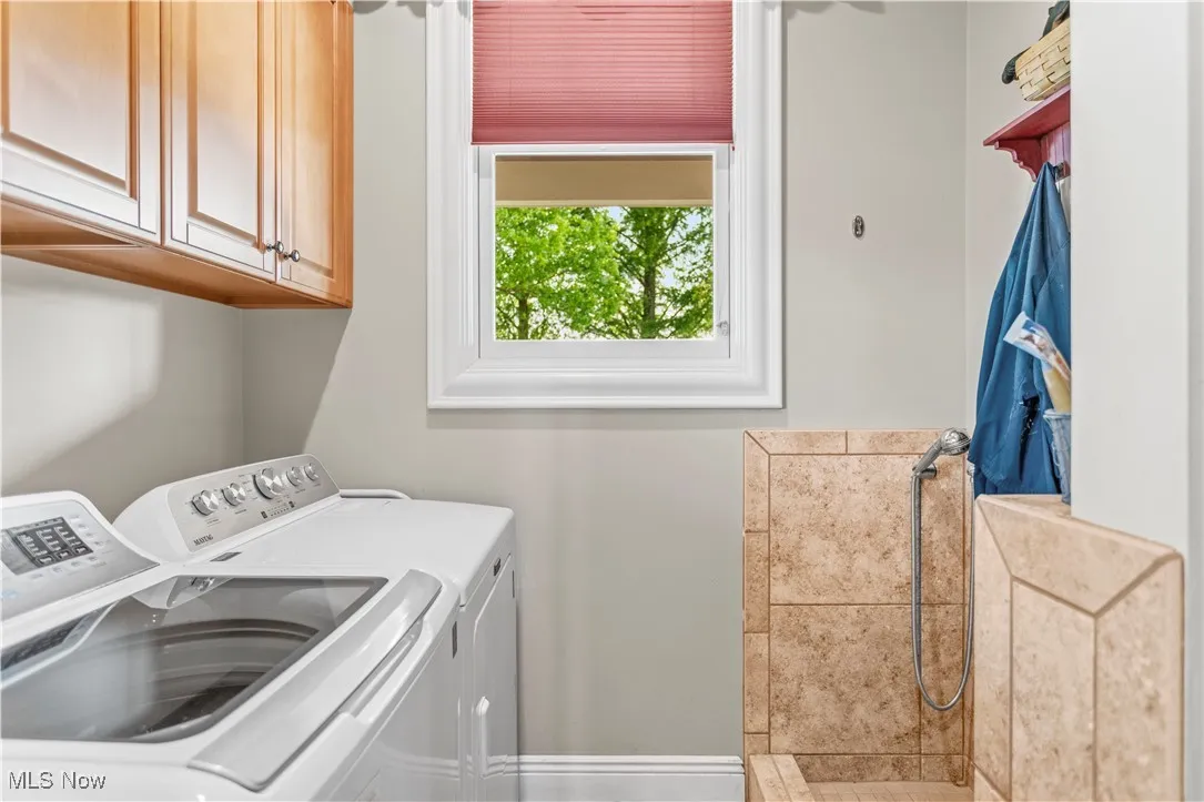 Washroom with washing machine and dryer and cabinet space
