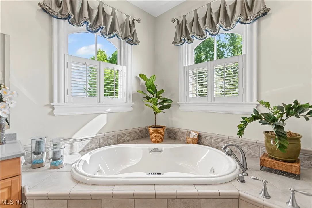 Full bath with a garden tub and vanity