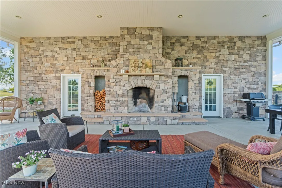 View of patio / terrace featuring a grill and an outdoor living space with a fireplace