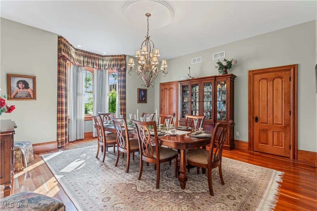 Dining room featuring a chandelier, light wood finished floors, and baseboards
