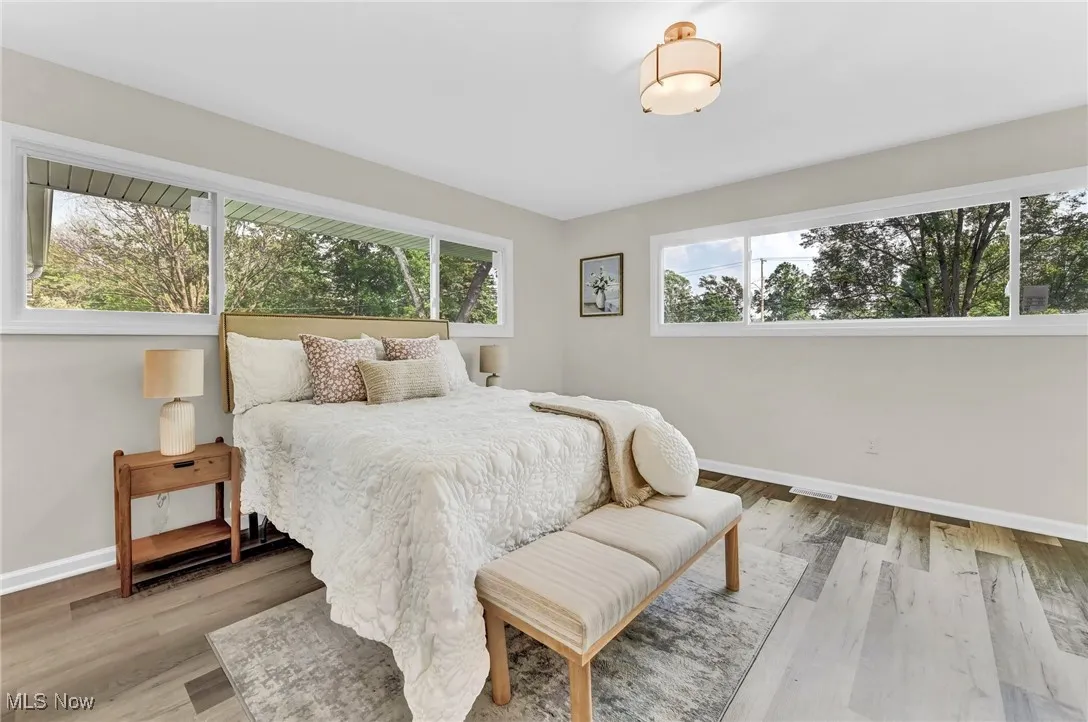 Bedroom with baseboards and wood finished floors