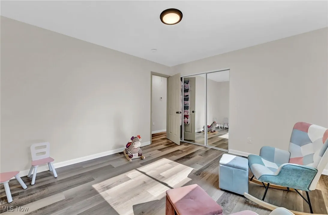 Sitting room with wood finished floors and baseboards