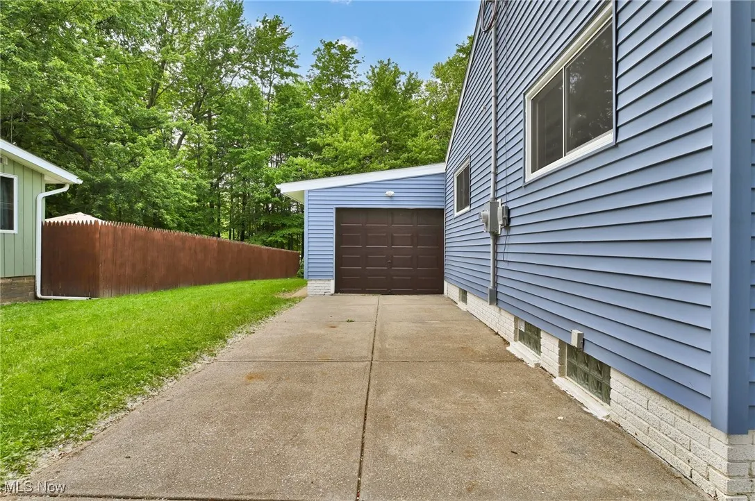 Garage featuring concrete driveway