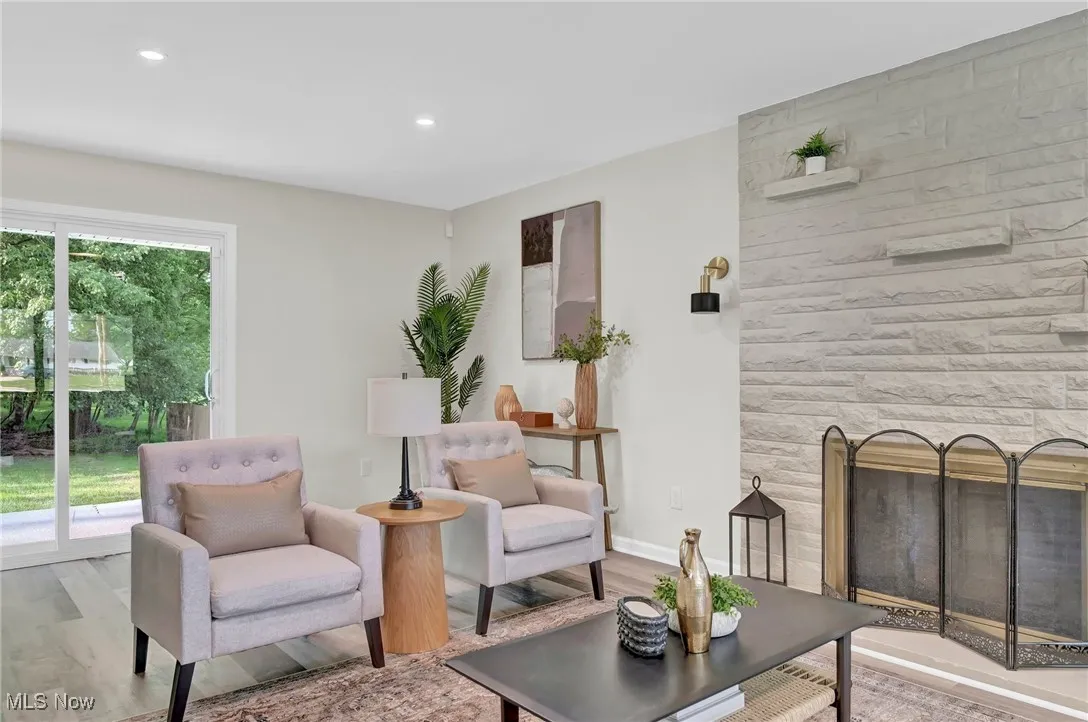 Living room featuring wood finished floors, recessed lighting, and baseboards
