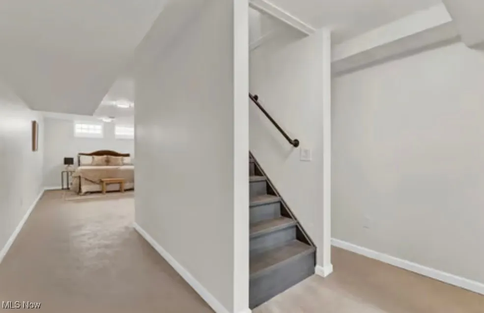 Staircase featuring baseboards