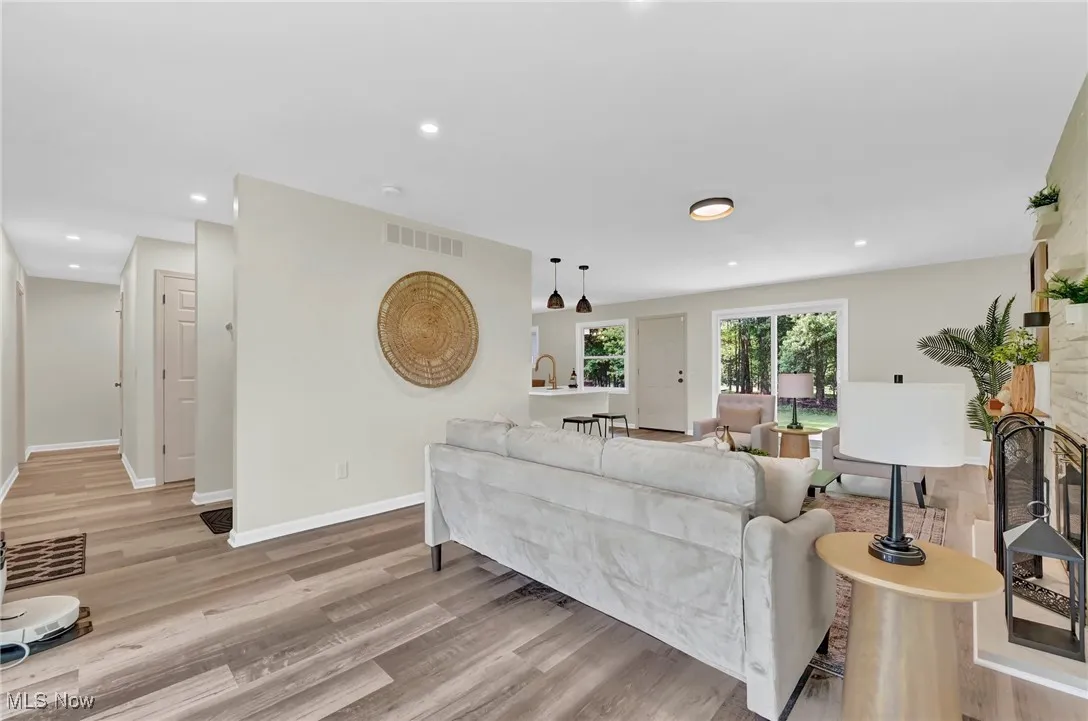Living room featuring wood finished floors, recessed lighting, and baseboards