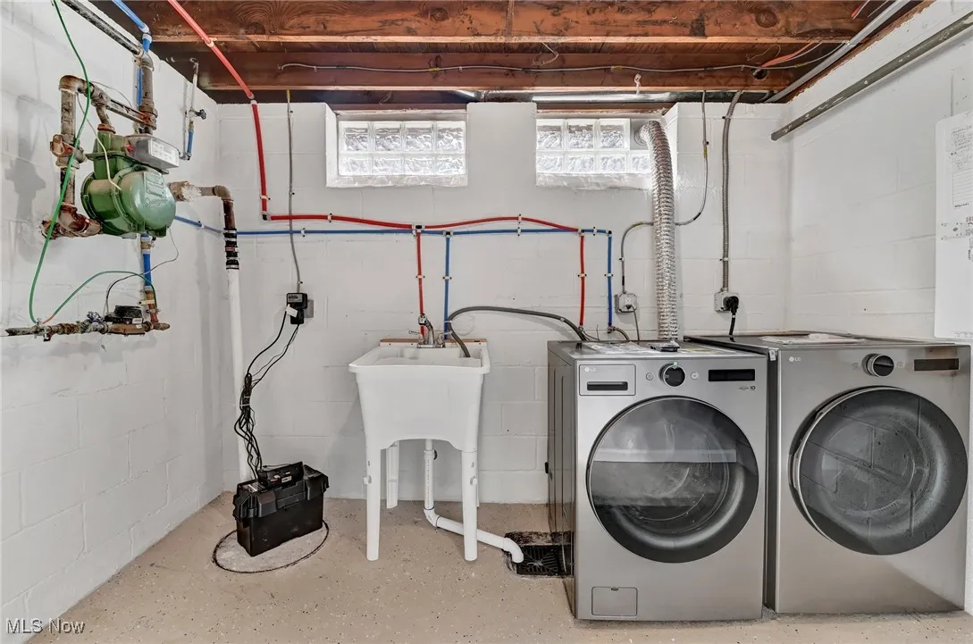Laundry area with washing machine and clothes dryer