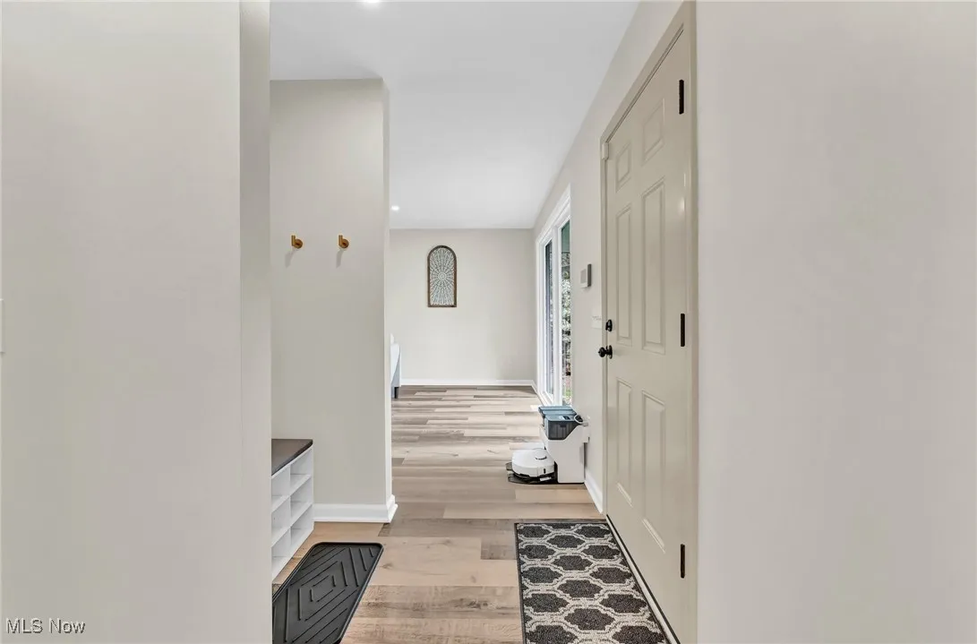Hall featuring light wood-style floors and baseboards