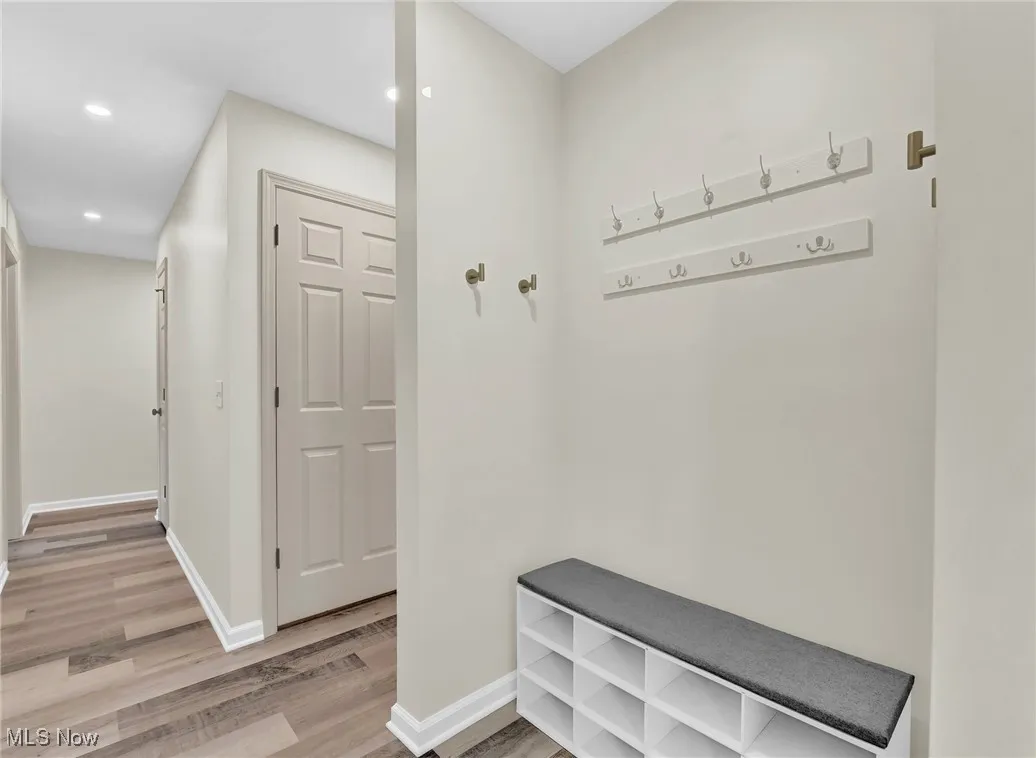 Mudroom featuring light wood-style floors, baseboards, and recessed lighting
