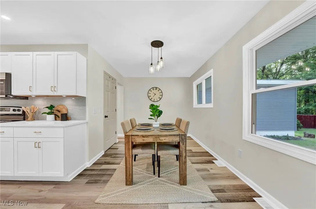Dining room featuring light wood-style flooring and baseboards