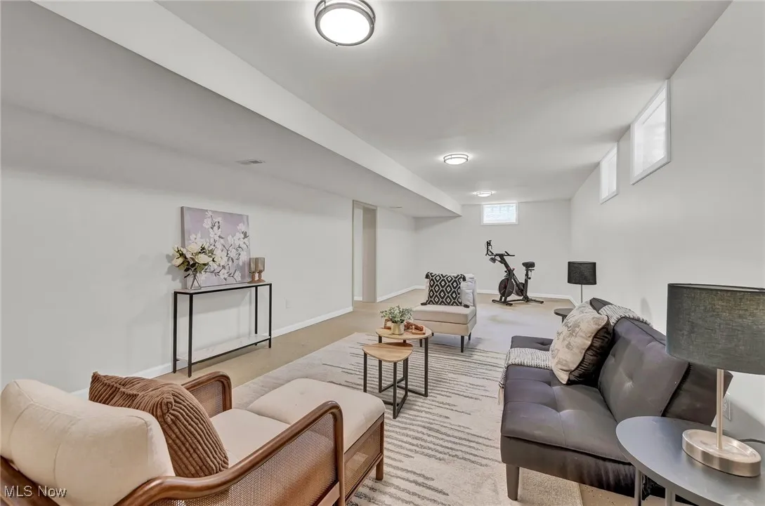 Carpeted living room featuring baseboards
