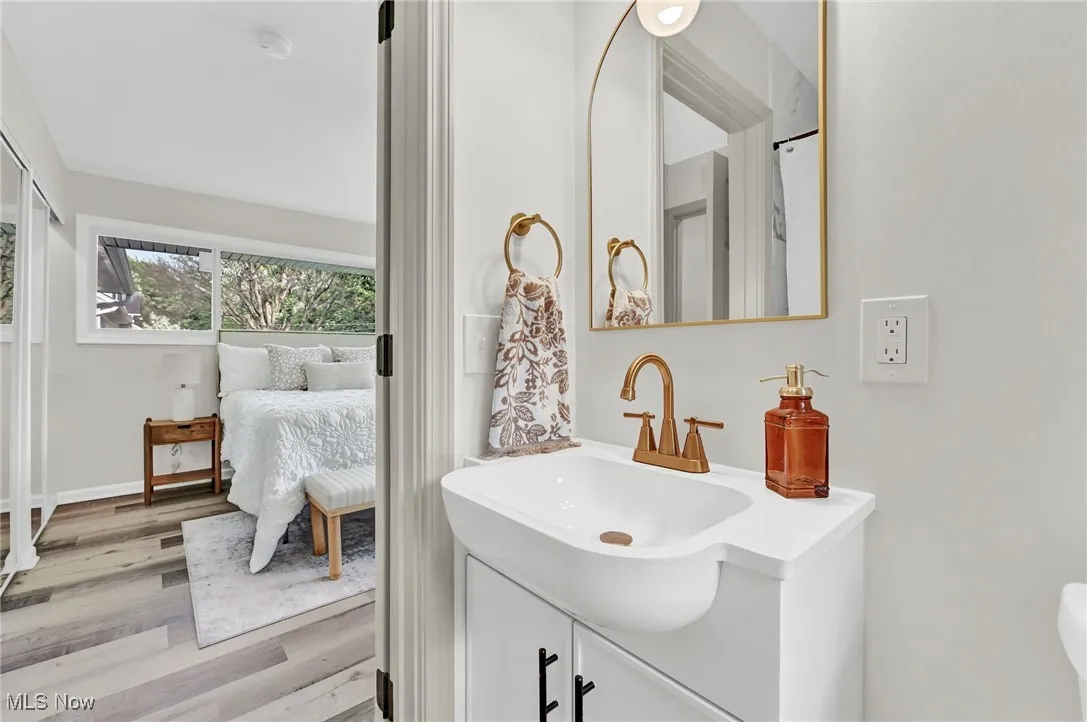 Ensuite bathroom featuring vanity and wood finished floors