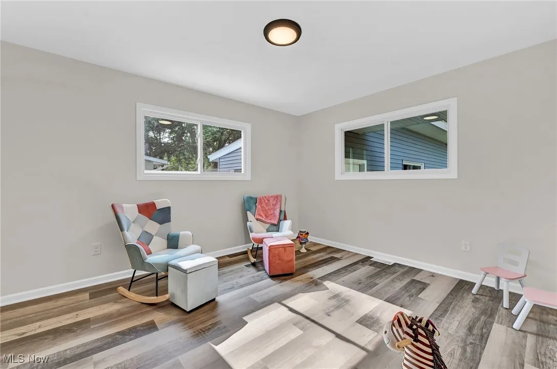 Living area with wood finished floors and baseboards