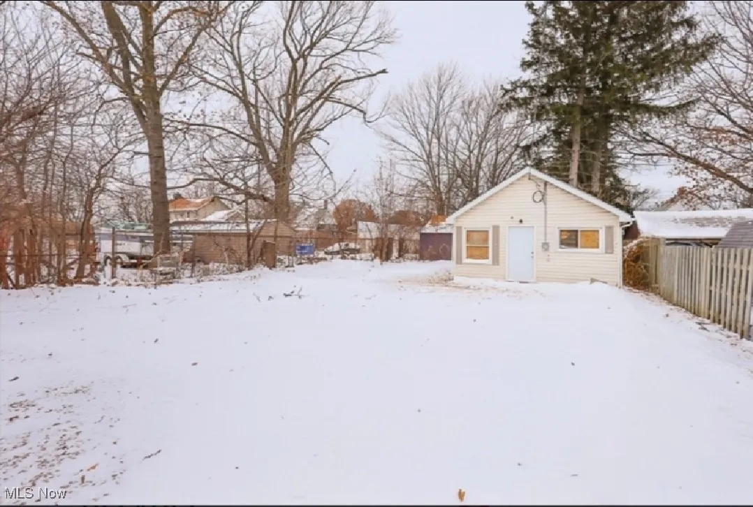 Snowy yard with an outdoor structure