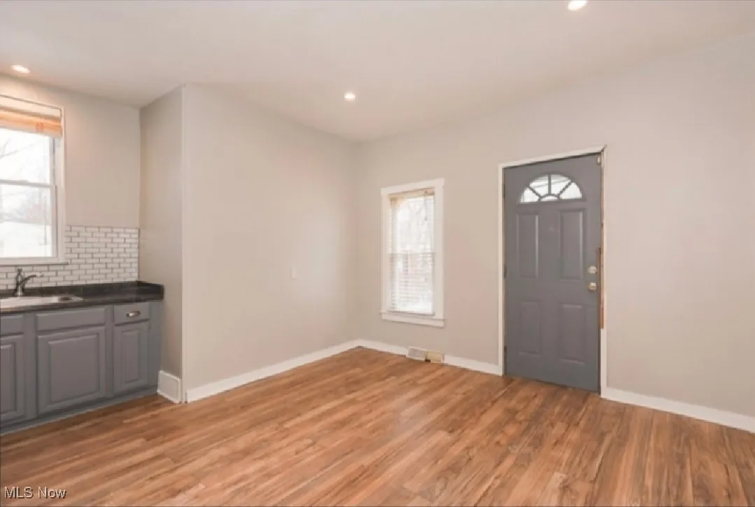 Foyer entrance with light wood finished floors, baseboards, and recessed lighting