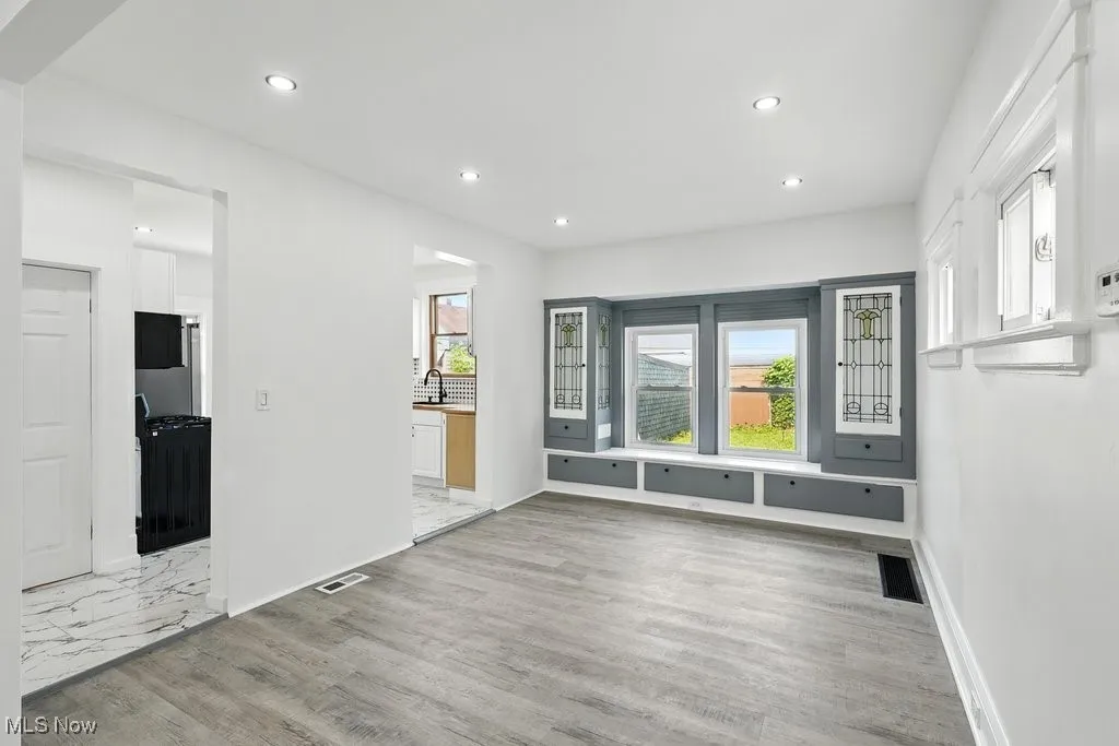 Unfurnished living room with recessed lighting, a sink, baseboards, and light wood-type flooring