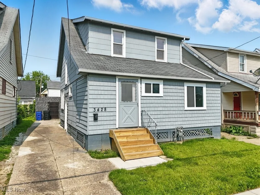 Back of property featuring roof with shingles, a yard, and crawl space