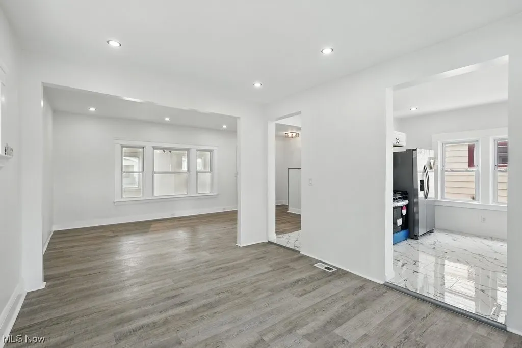 Spare room featuring wood finished floors, recessed lighting, and baseboards