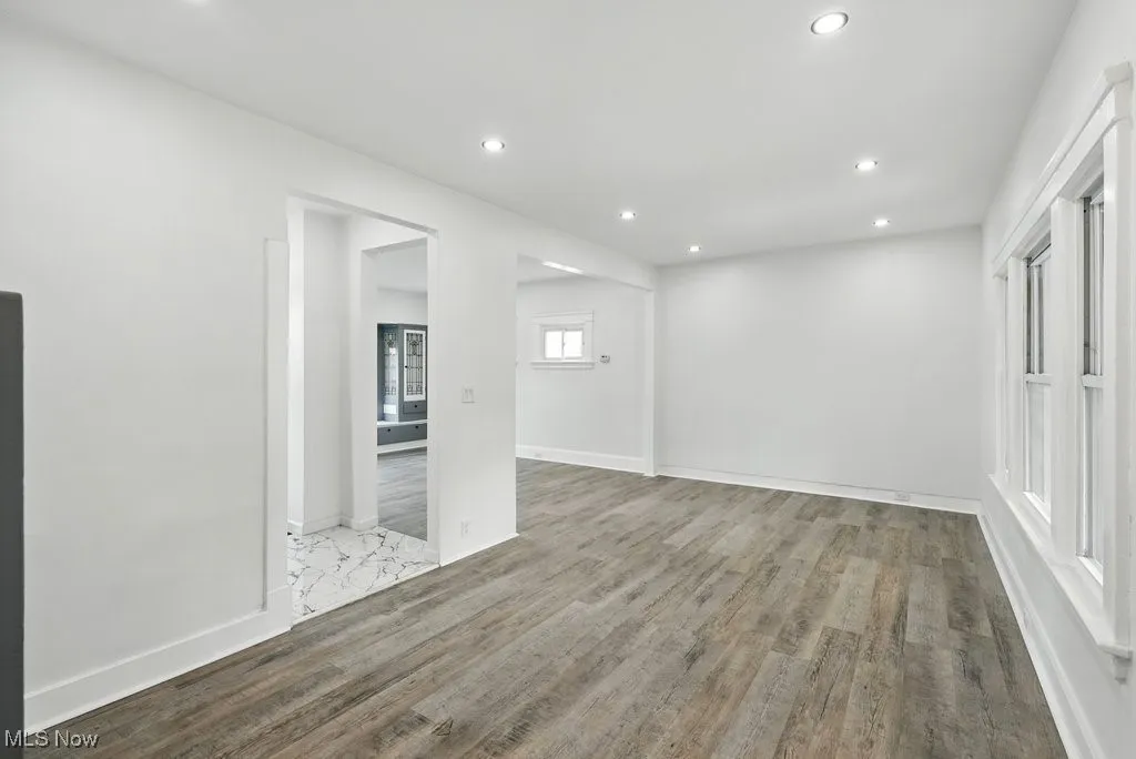 Empty room featuring recessed lighting, wood finished floors, and baseboards