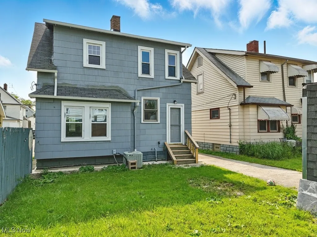 Back of property with a chimney and entry steps