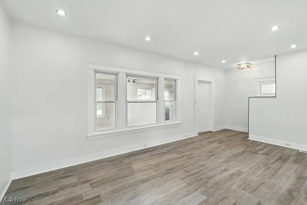Wood finished floors, recessed lighting, and baseboards