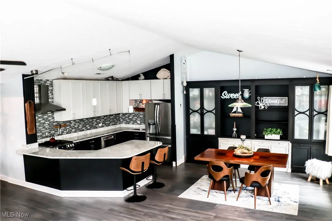Gorgeous custom kitchen with high end finishes opens to the dining room!