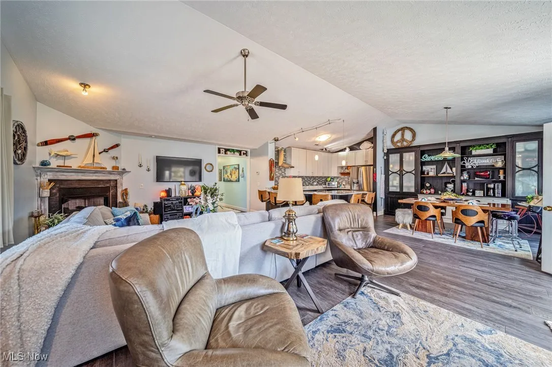 Open & vaulted great room looks into the custom kitchen & dining room!