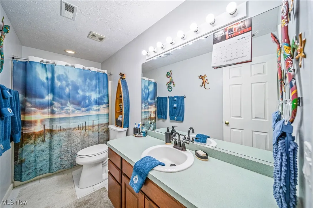 First full bathroom with ceramic tiled floor, newer ADA chair height toilet, extra spacious vanity & mirror!