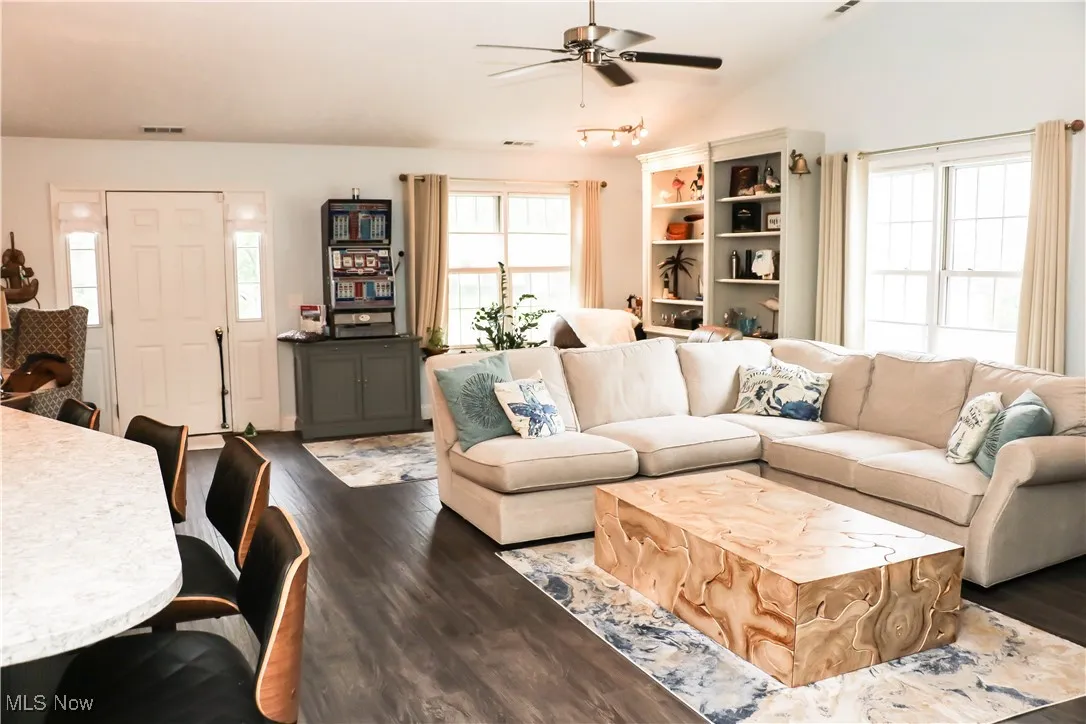 Open great room with sitting area, living room area, custom kitchen with gorgeous Cambria countertops & ceramic tiled flooring!